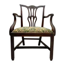 George III mahogany elbow chair, the shaped cresting rail carved with extending foliate motif over Gothic Chippendale design spat, drop-in upholstered seat, shaped arms over moulded seat frame, on square moulded supports joined by plain stretchers 