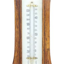Late Victorian carved oak aneroid barometer, the foliate crest above a glazed thermometer and circular dial, with further carved decoration below, H 75cm