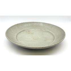 Andrew Crouch (born 1982), a large Studio Pottery celadon glazed dish, of circular form with reeded rim, with impressed seal mark beneath, D39.5cm.
