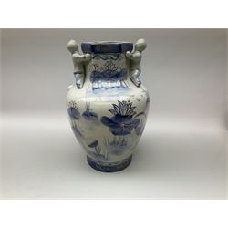Group of Oriental and Oriental style of ceramics, comprising large blue and white vase embellished with people and gilt detail, pair of seated dogs with a floral decoration on a yellow ground, pair of vases with relief detail, together with stone figure of a fisherman. 
