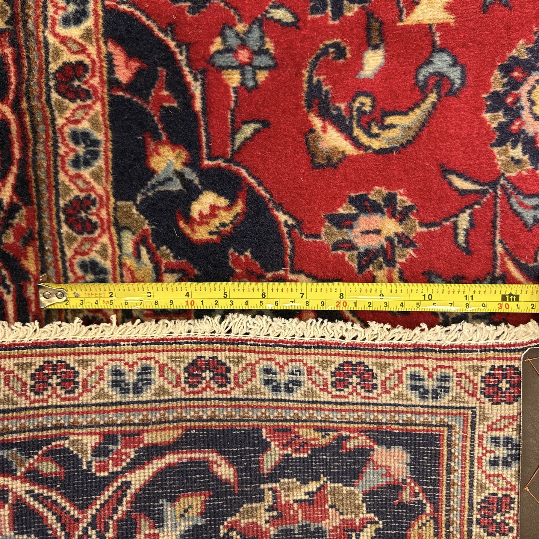 Central Persian Kashan rug, crimson ground with central medallion with  quarter medallions in each corner and decorated with floral sprays and palmettes, dark blue main border with repeating palmette and vine pattern   framed by small guard border with floral meanders 