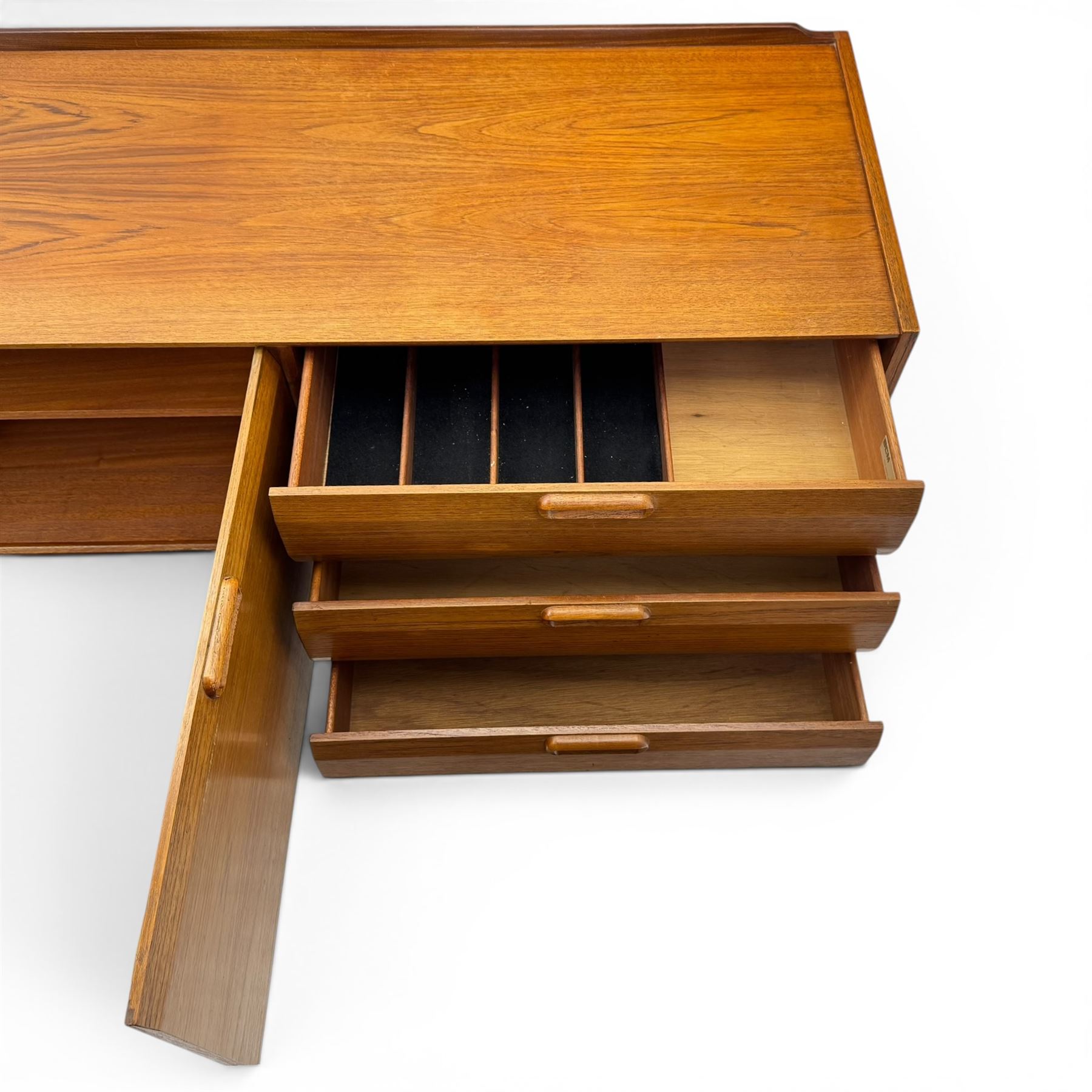 BCM (Bath Cabinet Makers) - mid-20th century teak sideboard, rectangular top with back gallery, left hand side fall front cupboard, centre cupboard opening to reveal a shelved interior, the right side with a bank of three drawers one fitted for cutlery, raised on inset tapering supports