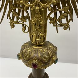 20th century gilt metal monstrance, in the Gothic revival style, with glazed aperture to centre surrounded with clear paste stones, in a pierced floral and scroll border set with coloured paste stones, within a sunburst surround, on a paste set knopped stem and similar foliate foot, H59.3cm