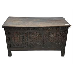 English carved oak coffer, hinged rectangular lid with indented side edges, internal candle-box, front with three-panel front with decorative carvings, raised on stile feet, circa 1700