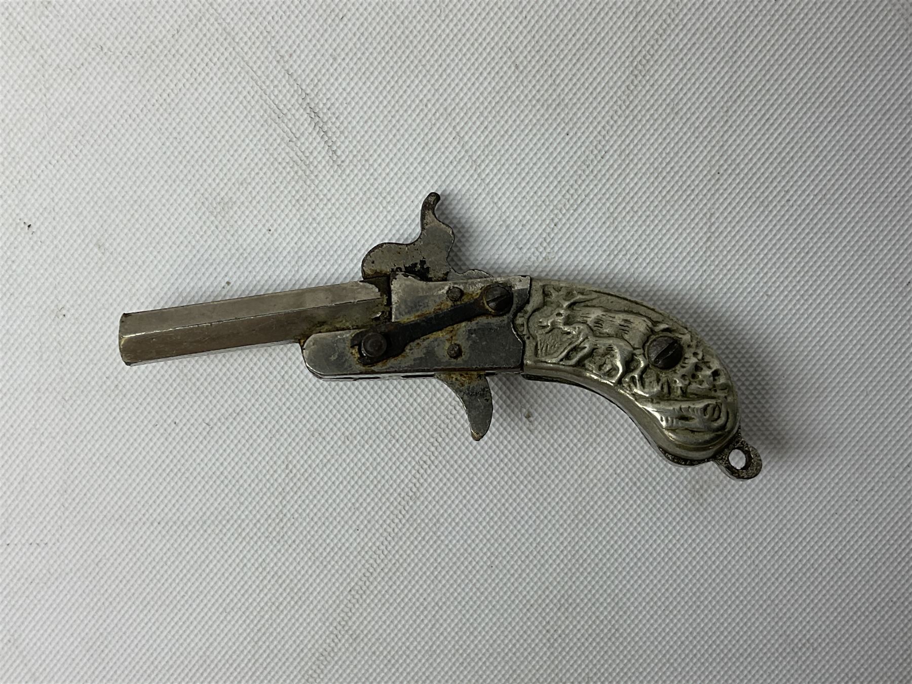 Miniature all nickel 2mm pin fire single shot pistol with engraved grip L4.5cm; together with a .925 silver half hunting cased keyless wind pocket watch inscribed 'Presented to Pte. P. Sizer By No.2 Company 1st Battalion Lincolnshire Regmt For Gallant Conduct Nr. Cork (Ireland) 31.7.20' (2)