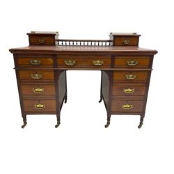 Maple & Co - Edwardian mahogany twin pedestal desk, the raised back with spindle gallery and open shelf to centre flanked by two trinket drawers, rectangular top with inset writing surface, fitted with one long and eight short graduating drawers flanked by fluted uprights, raised on brass and ceramic castors, stamped to central drawer