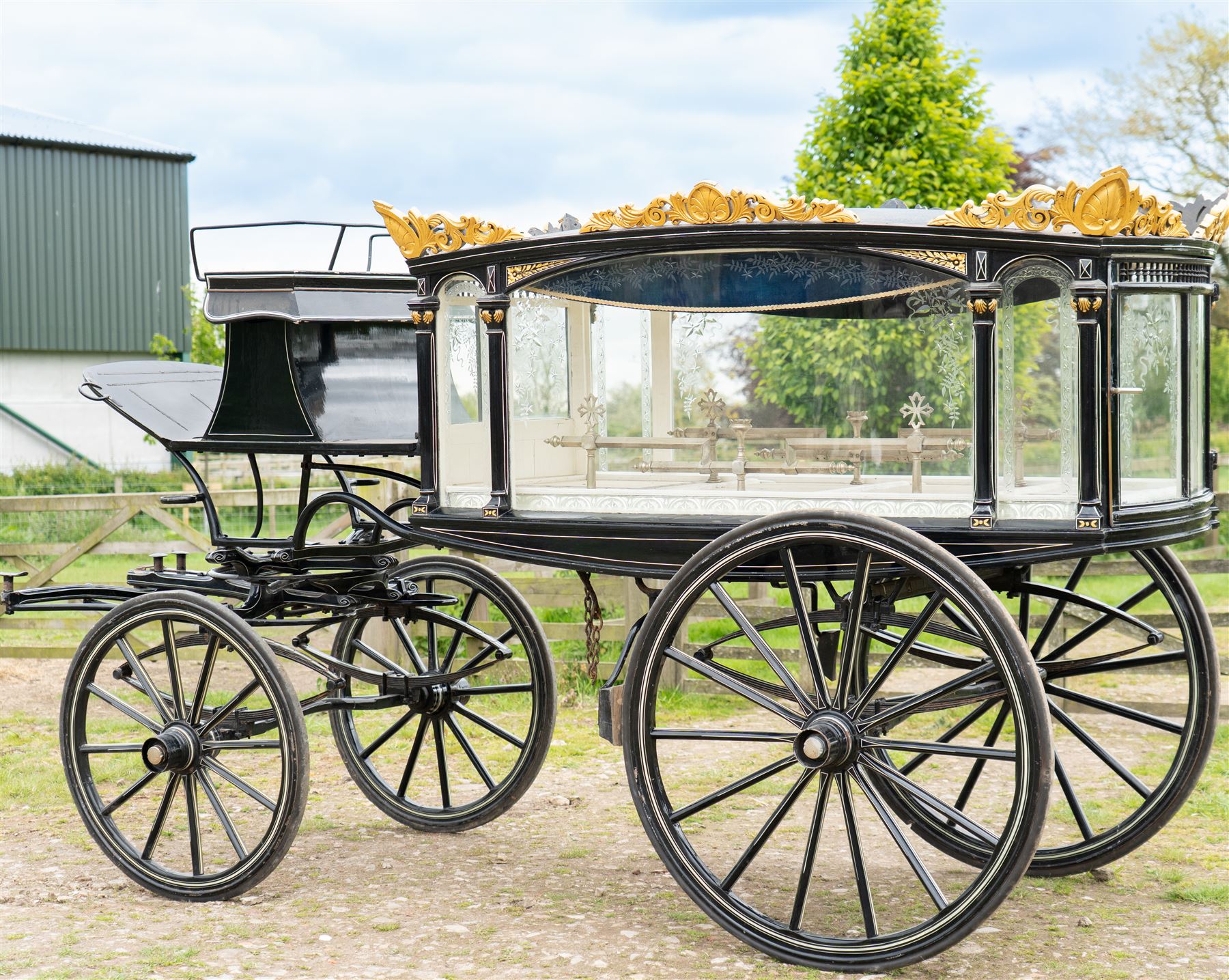 Victorian Glass Hearse

A black painted four wheeled horse drawn glass hearse with extensively glazed coffin compartment, etched glass side and end panels, decorative gilt cresting, gilt column capitals, white painted interior bier deck, metal coffin rails with cross finials, rear glazed access doors, external coachman's box seat for two, wooden spoked wheels the wheel hubs stamped 'The Economic Funeral Co', leaf spring suspension, underbody turntable steering and pole for driving with a pair of horses. The hearse has decorative painted lining throughout and an ornate black and gilt body with curved glass panels to the sides and rear.

Features

• Extensively glazed coffin compartment
• Etched glass side and end panels
• Decorative gilt cresting
• Gilt column capitals
• White painted interior bier deck
• Metal coffin rails with cross finials
• Rear glazed access doors
• External coachman's box seat
• Wooden spoked wheels
• Leaf spring suspension
• Underbody turntable steering
• Pole for driving with a pair of horses
• Decorative painted lining

Dimensions:
Overall length: 406 cm
Body length: 250 cm
Overall width: 190 cm
Body width: 115 cm
Height: 228 cm

Wheel Diameters:
Front wheels: 102 cm
Rear wheels: 133 cm

Seating

Coachman's box seat: 2