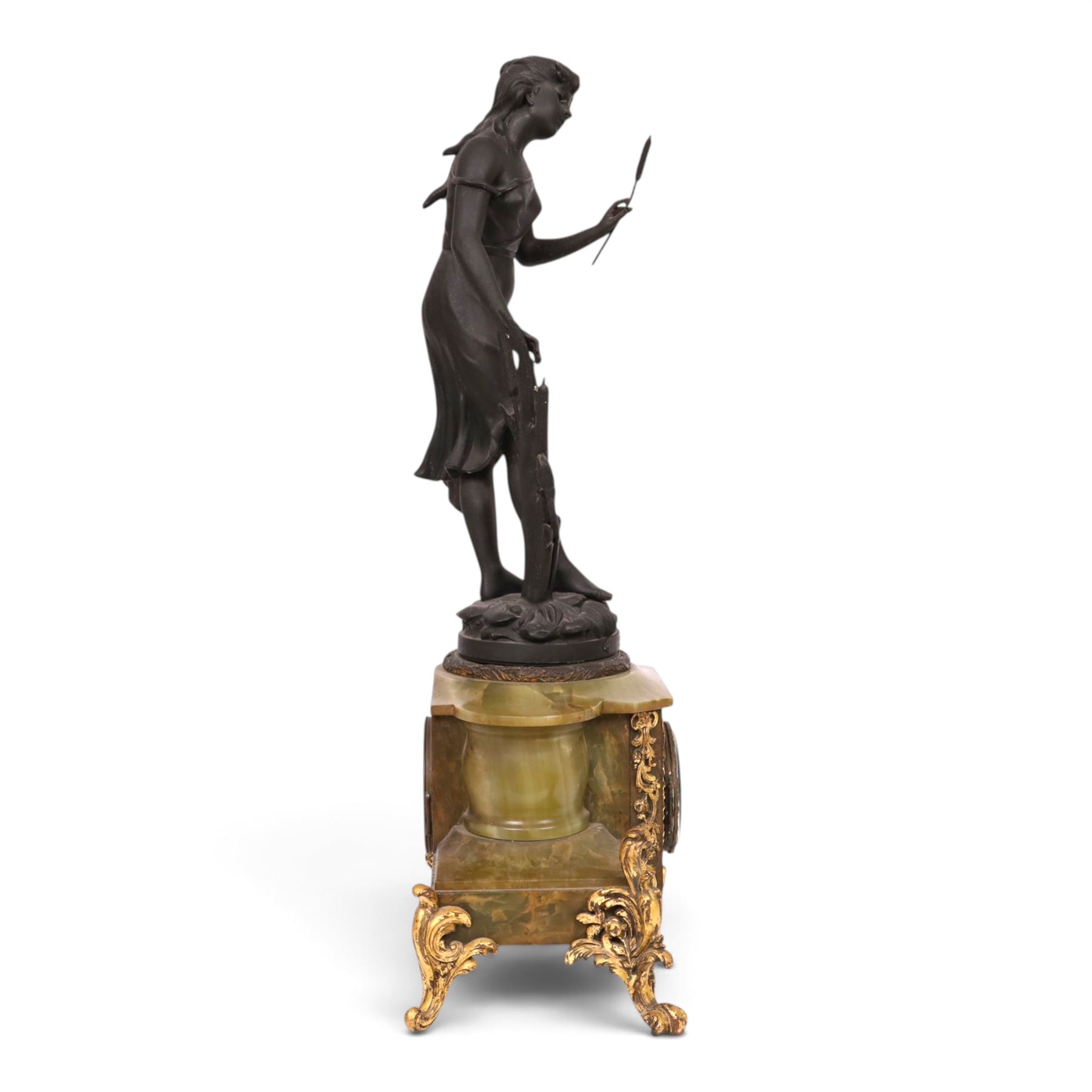 French green onyx clock, surmounted by a female figure amongst rushes, the enamel clock face with floral sprigs, H74cm 
