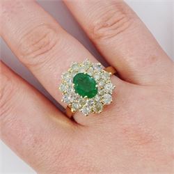 14ct gold emerald and diamond cluster ring, single oval cut emerald of approx 1.05 carat, surrounded by two rows of twenty four round brilliant cut light yellow diamonds, total diamond weight approx 2.35 carat