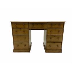 Early 20th century light ash twin pedestal desk, rectangular top with inset leather, nine drawers, plinth base