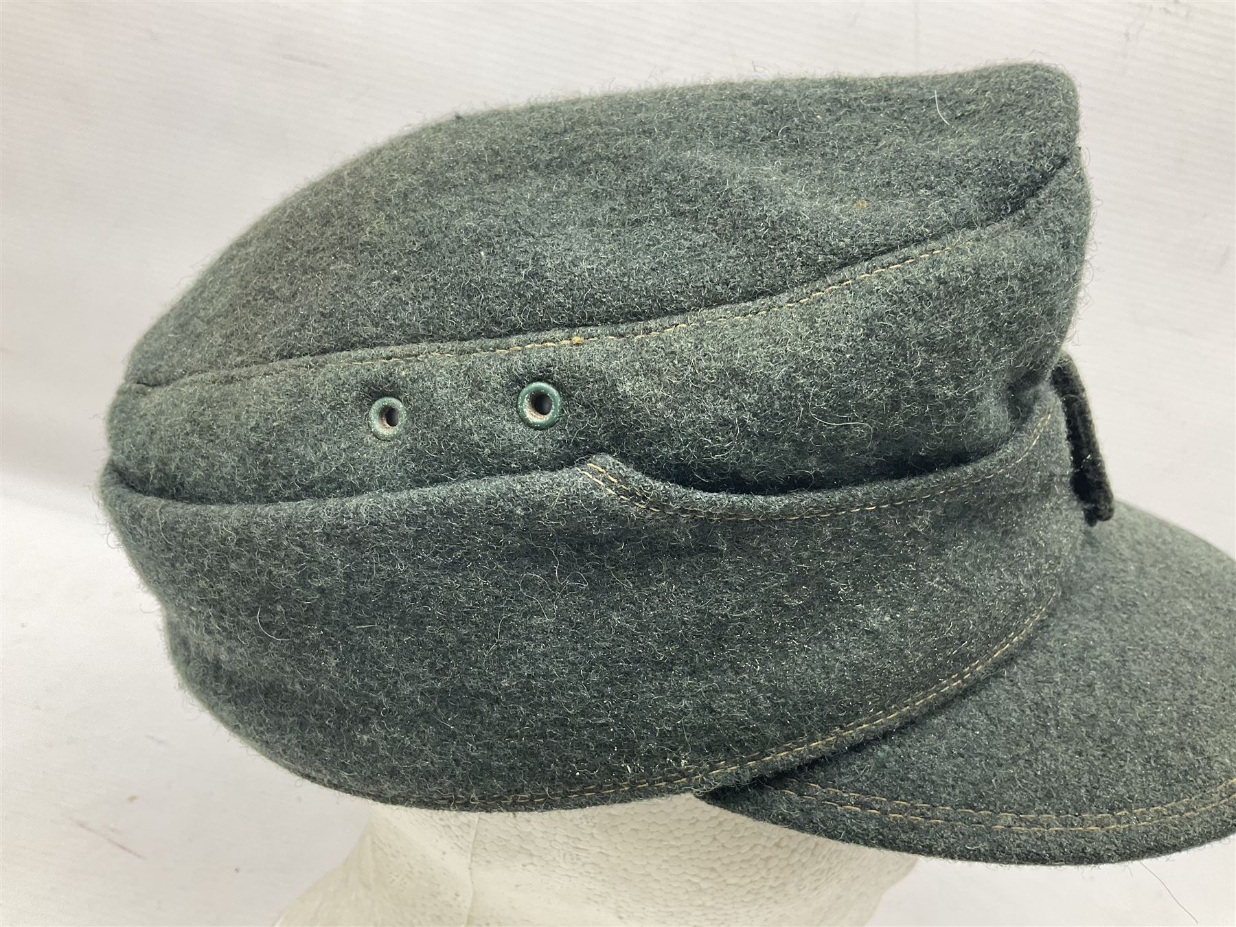 WWII German M43 field cap with 'SS' cloth badge and mountain trooper's edelweiss metal badge