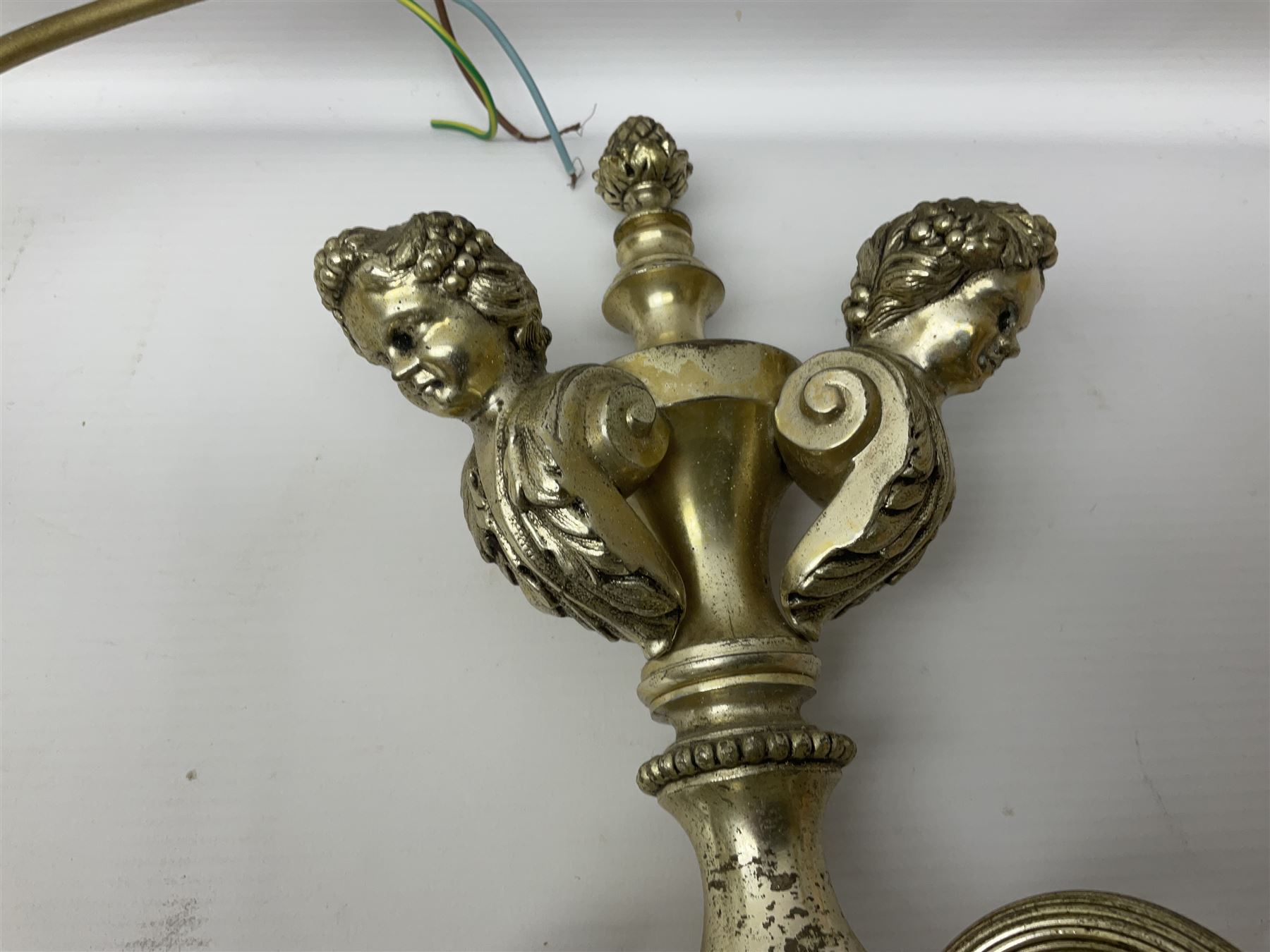 Siz branch silvered chandelier, decorated with acanthus leaves and putti, together with two matching three branch wall sconces, chandelier D65cm