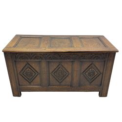 18th century oak coffer or chest, rectangular triple panelled hinged top with moulded edge enclosing main compartment and candle box, the frieze carved with repeating concentric lunettes and foliate patterns, the front fielded panels decorated with lozenges containing central flower heads, on stile supports