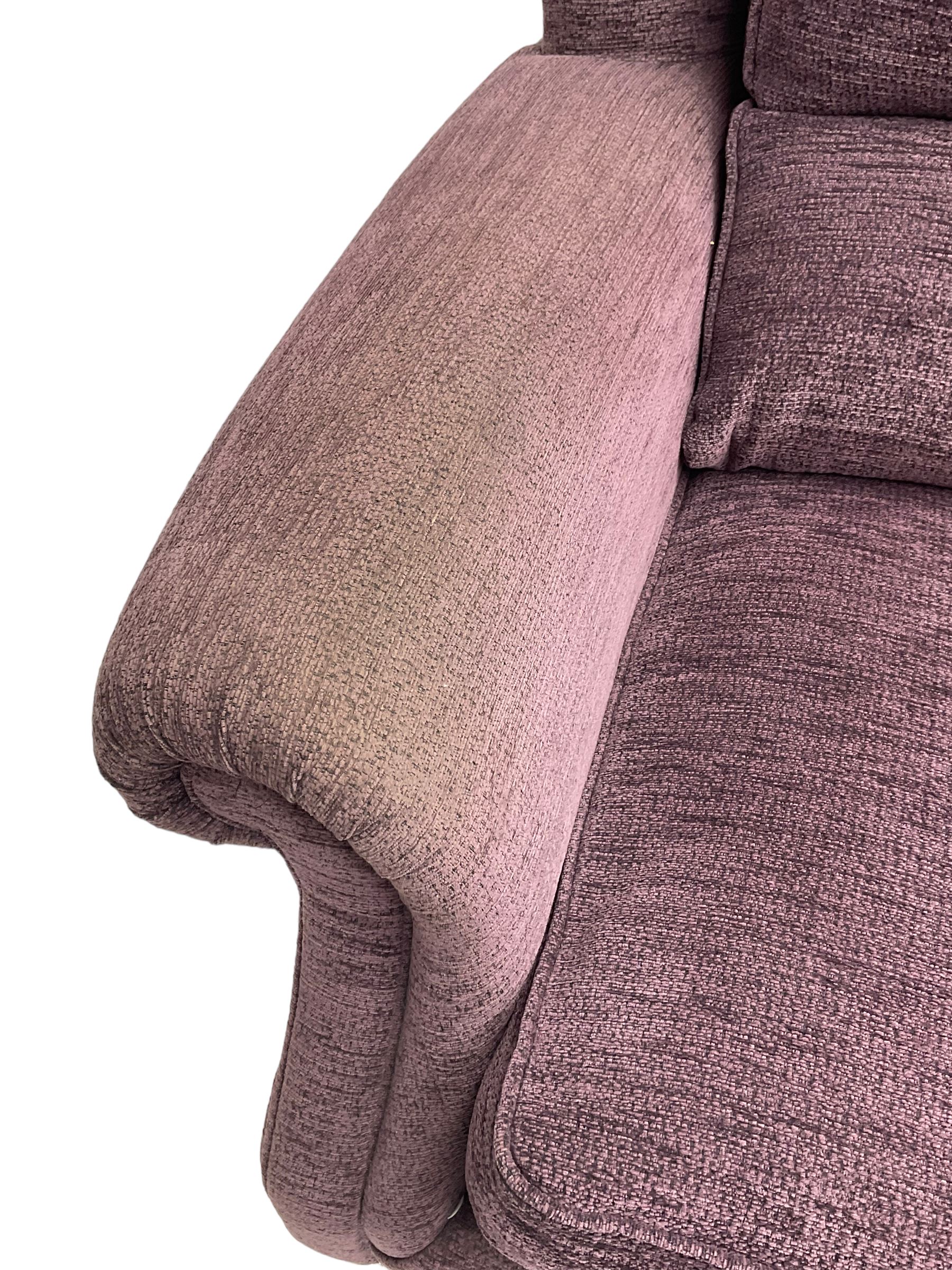 Parker Knoll - pair of large two-seat sofas upholstered in purple fabric, turned mahogany finish front feet with brass cups and castors 