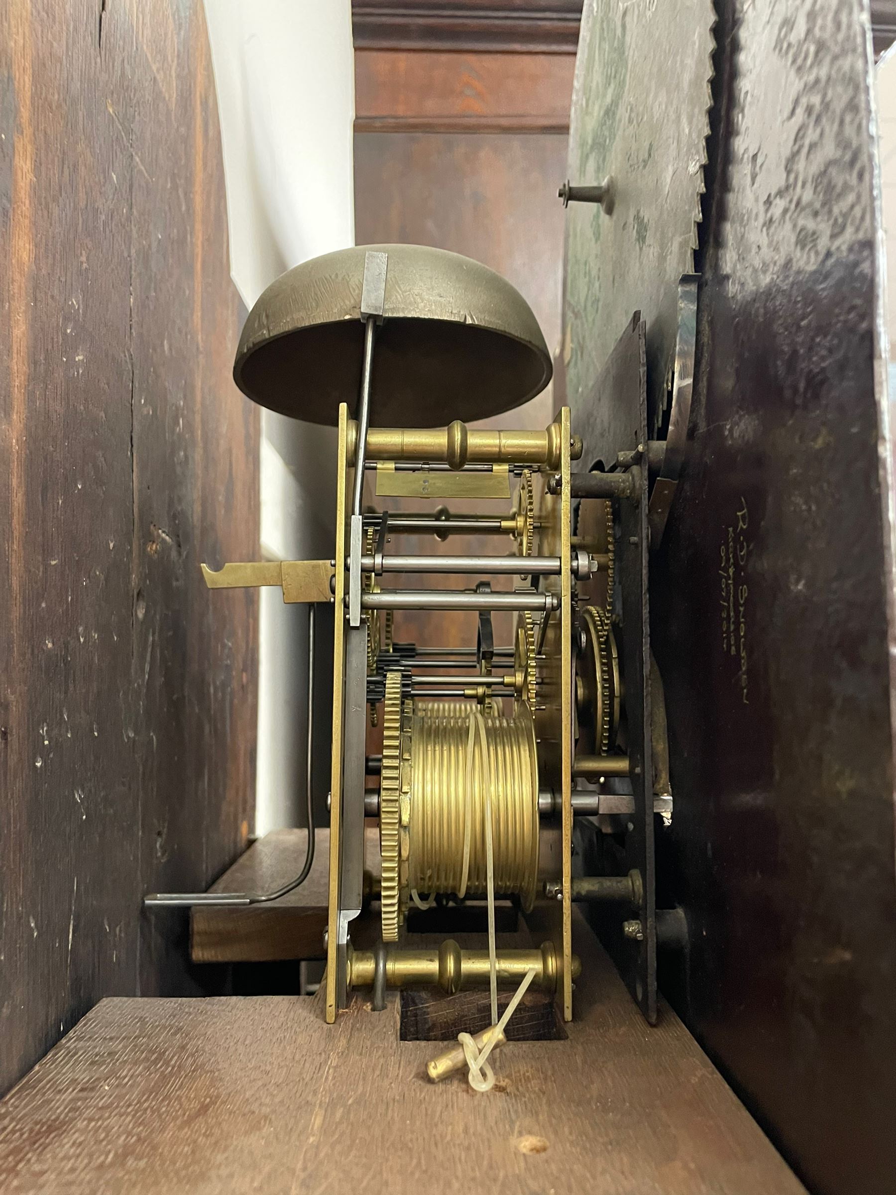 Penlington of Liverpool – early 19th century 8-day mahogany longcase clock, swans neck pediment with three turned wooden finials and verre eglomise panels, trunk with reeded columns and wavy topped door, plinth with canted corners on bracket feet, painted break-arch dial with Roman numerals and five-minute Arabic’s, centre sweep calendar and seconds hands, blue steel serpentine hands, signed beneath a painted rolling moon in the arch PENLINGTON, LIVERPOOL, eight day four pillar movement, anchor escapement and rack striking on a bell. With pendulum and weights.  The Penlington family were prolific clockmakers in 19th century Liverpool working from several addresses in the city, also recorded as chronometer and chronograph makers.