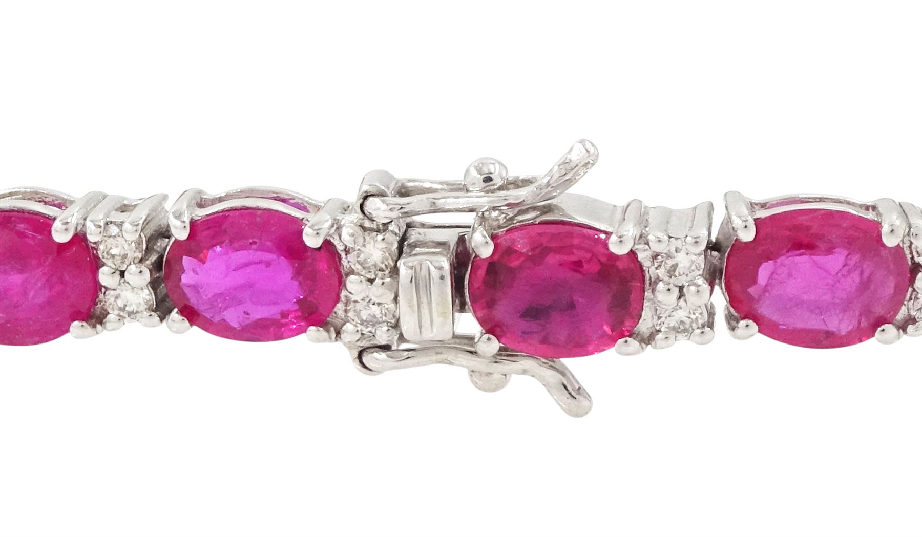 18ct white gold ruby and diamond bracelet, twenty-six oval cut rubies, each spaced by two round brilliant cut diamonds, hallmarked, total ruby weight approx 9.40 carat, total diamond weight 0.50 carat
