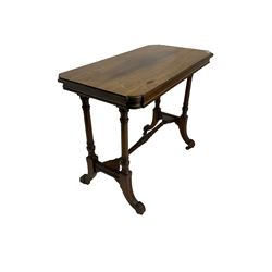 Late Victorian rosewood stretcher table, the rectangular top with curved canted cornice and moulded edge, on quadruple turned pillar supports carved with foliage, joined by collar turned stretcher, on splayed moulded supports with brass and ceramic castors