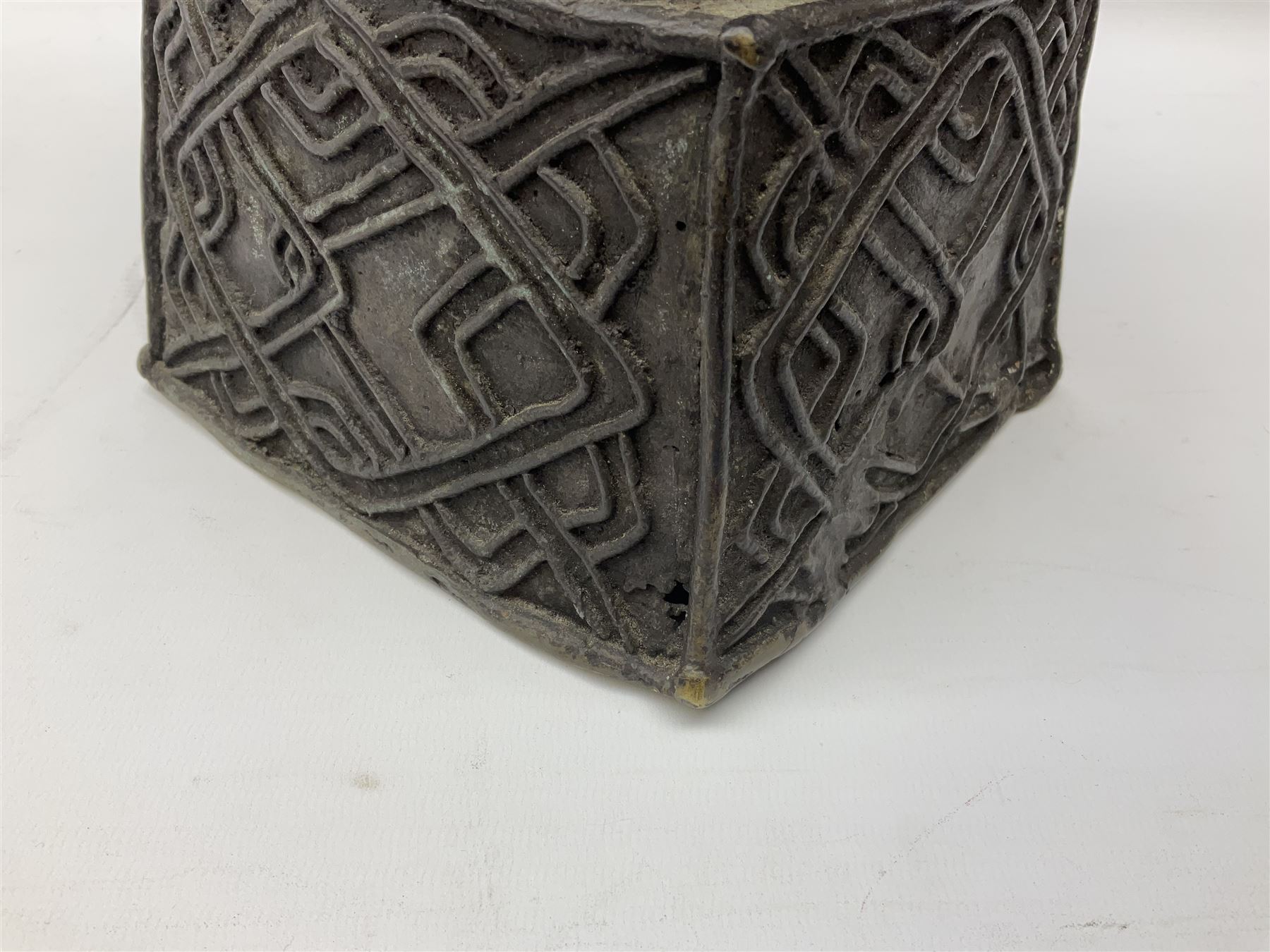 20th century Benin bronze head of an Oba, donning headdress and neck rings with wide open eyes, raised upon a tapering square base, the sides with relief cast knot decoration, H39cm