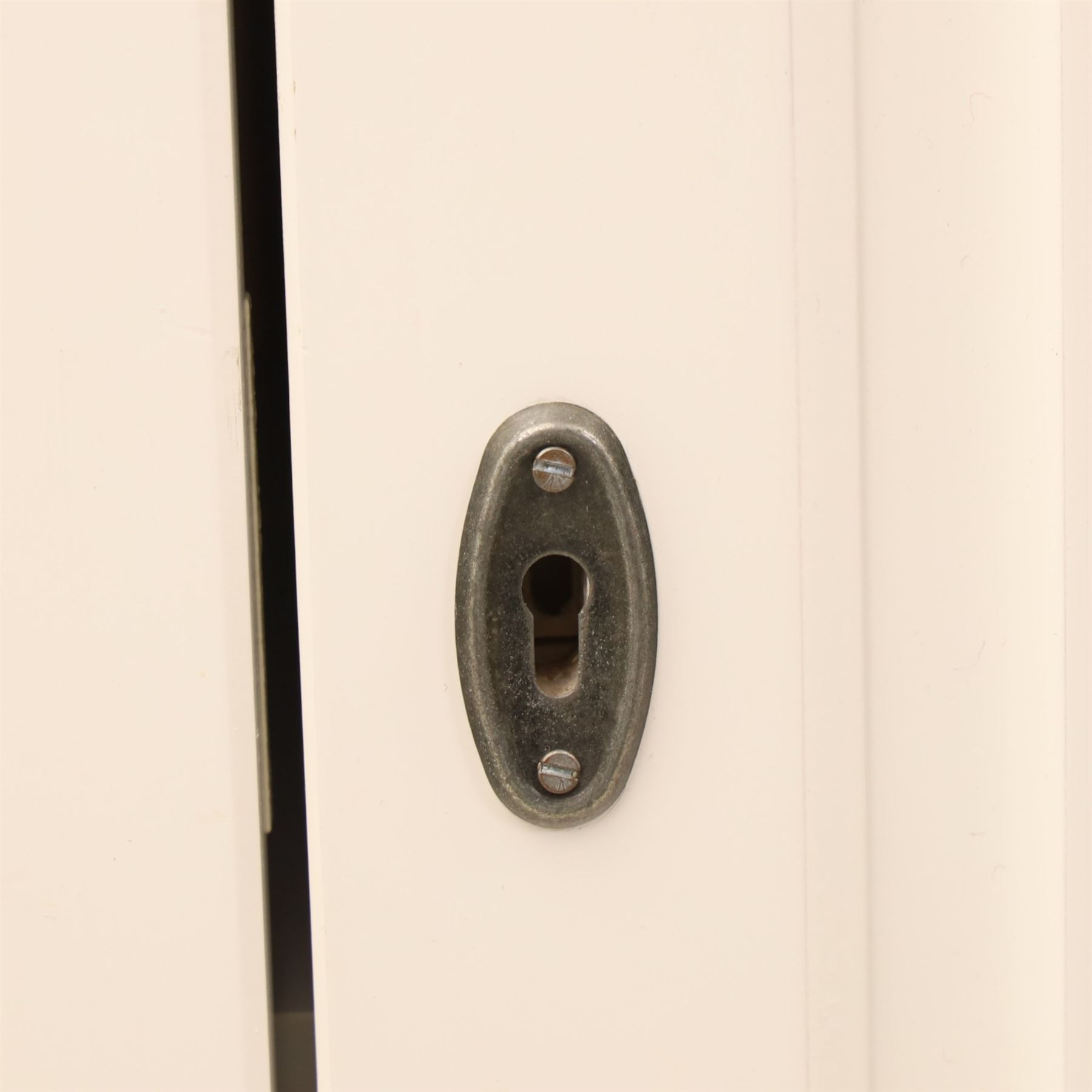 Modern white painted double wardrobe, fitted with two panelled doors, enclosing a hanging rail and shelving, raised on bracket feet