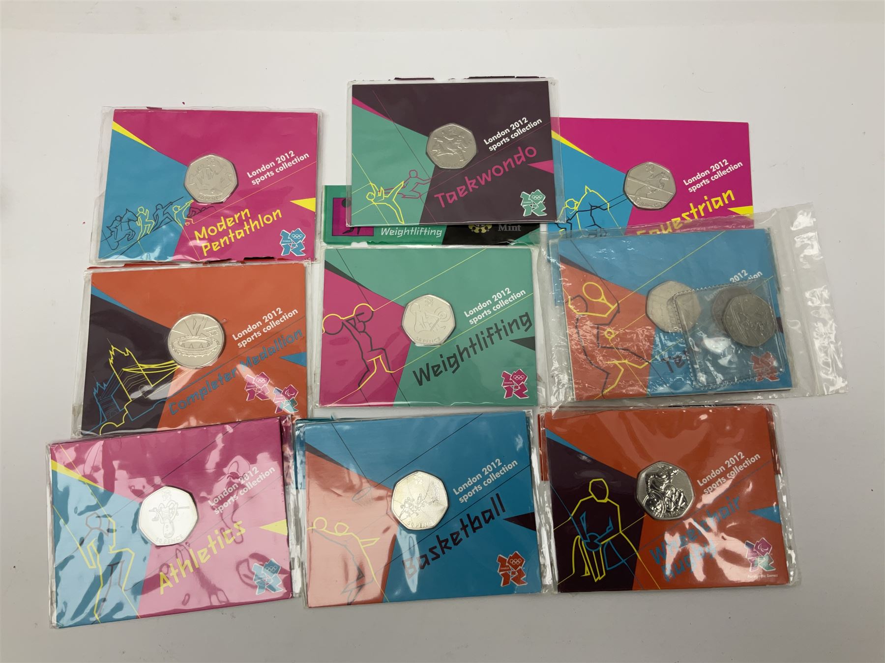 Commemorative and other coinage, including various Queen Elizabeth II 'London 2012 sports collection' fifty pence coins on cards, commemorative crowns, Millennium 2000 'Time Capsule' coin set, channel islands old round one pound coins, part sets etc