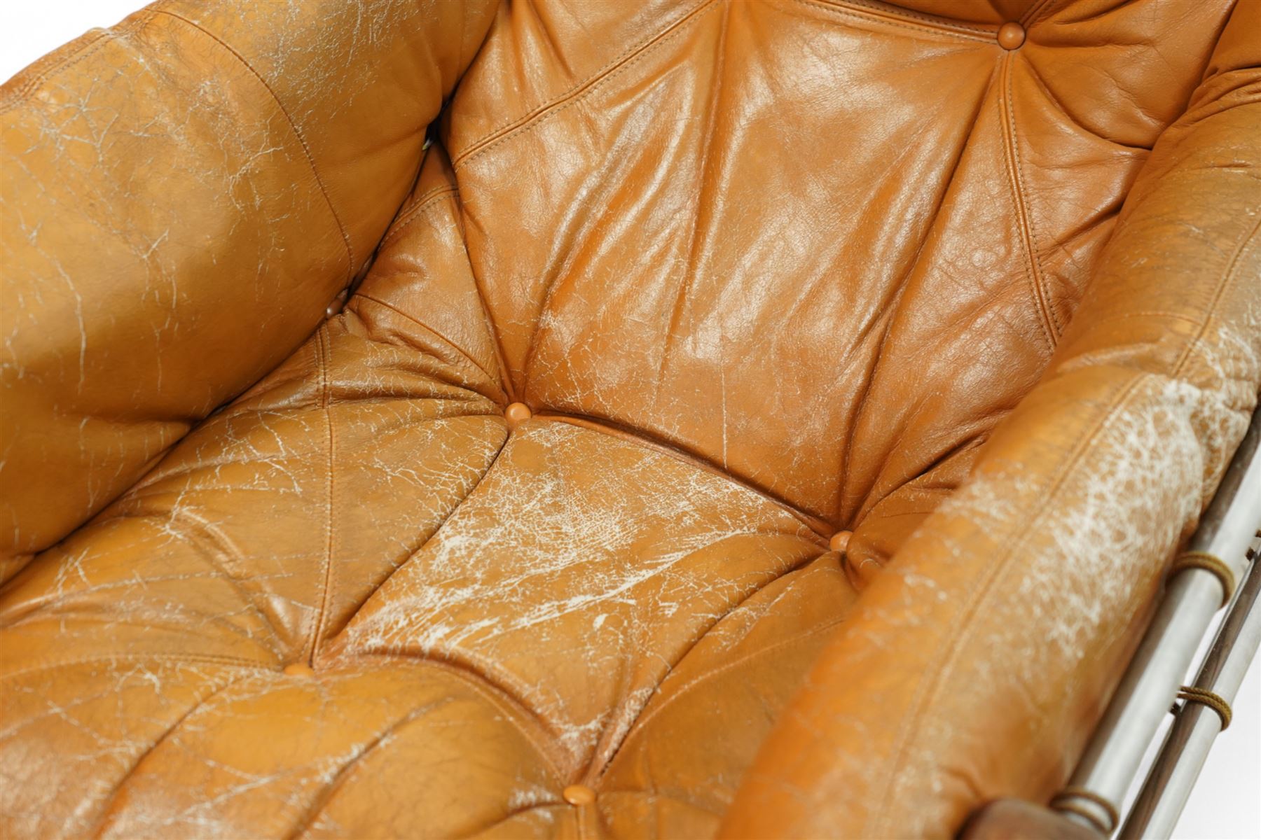 Jean Gillon (Romanian/Brazilian 1919-2007): 'Amazonas' easy chair, mahogany framed with slung leather upholstered cushions, together with matching footstool