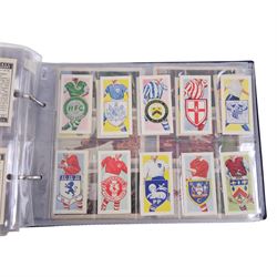 Collection of 1930s and later Football related trading and cigarette cards, including complete set of sixteen 1936 Topical Times Panel Portraits of Star Footballers, collection of further 1930s Footballer Panel Portraits, complete set of twenty-five 1955 The Wizard Famous Footballer cards, complete set of fifty Wills Association Footballers 1935, complete set of fifty Godfrey Phillips International Caps cards, etc, housed in three albums