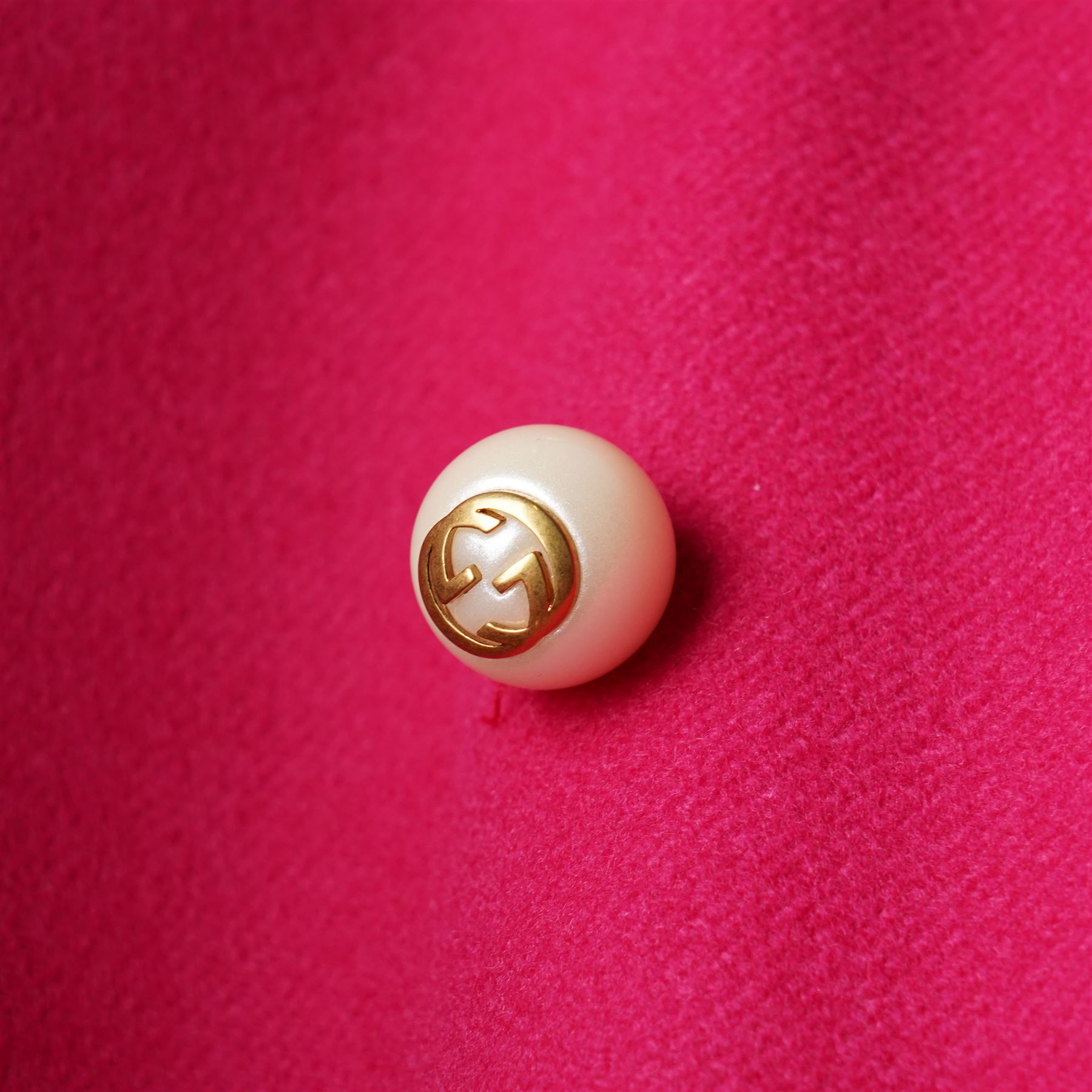 Gucci - wool ruffle-front single-breasted coat in bright fuchsia pink, with high ruffled collar, cascading ruffle trim to the front, collar and cuffs, faux pearl and gilt GG monogram logo button fastening, size 44, unused with the original garment bag and hanger