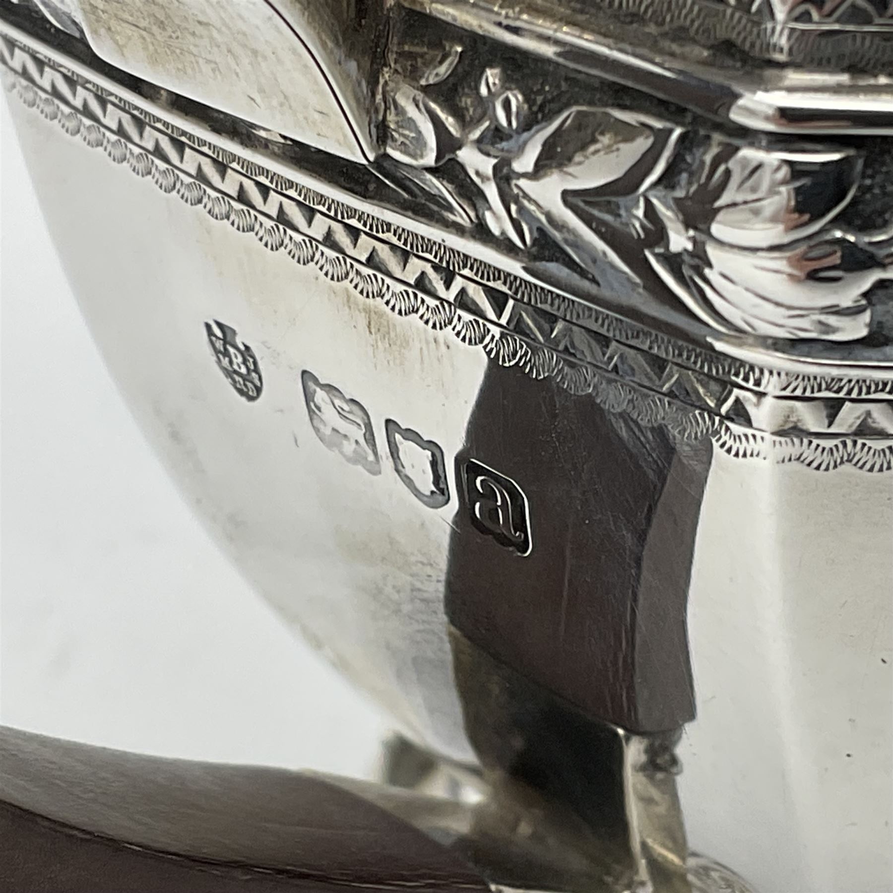 Victorian silver four piece tea service, comprising teapot, teapot stand, twin handled open sucrier and milk jug, each of octagonal form with foliate bud border and engraved decoration including crest to canted panels, and vacant panels, the teapot with ivory finial to the hinged cover and later wooden handle, hallmarked Edward Barnard & Sons Ltd, London1896, teapot including finial H15cm, milk jug including handle H16cm, teapot stand W11.5cm

This item has been registered for sale under Section 10 of the APHA Ivory Act