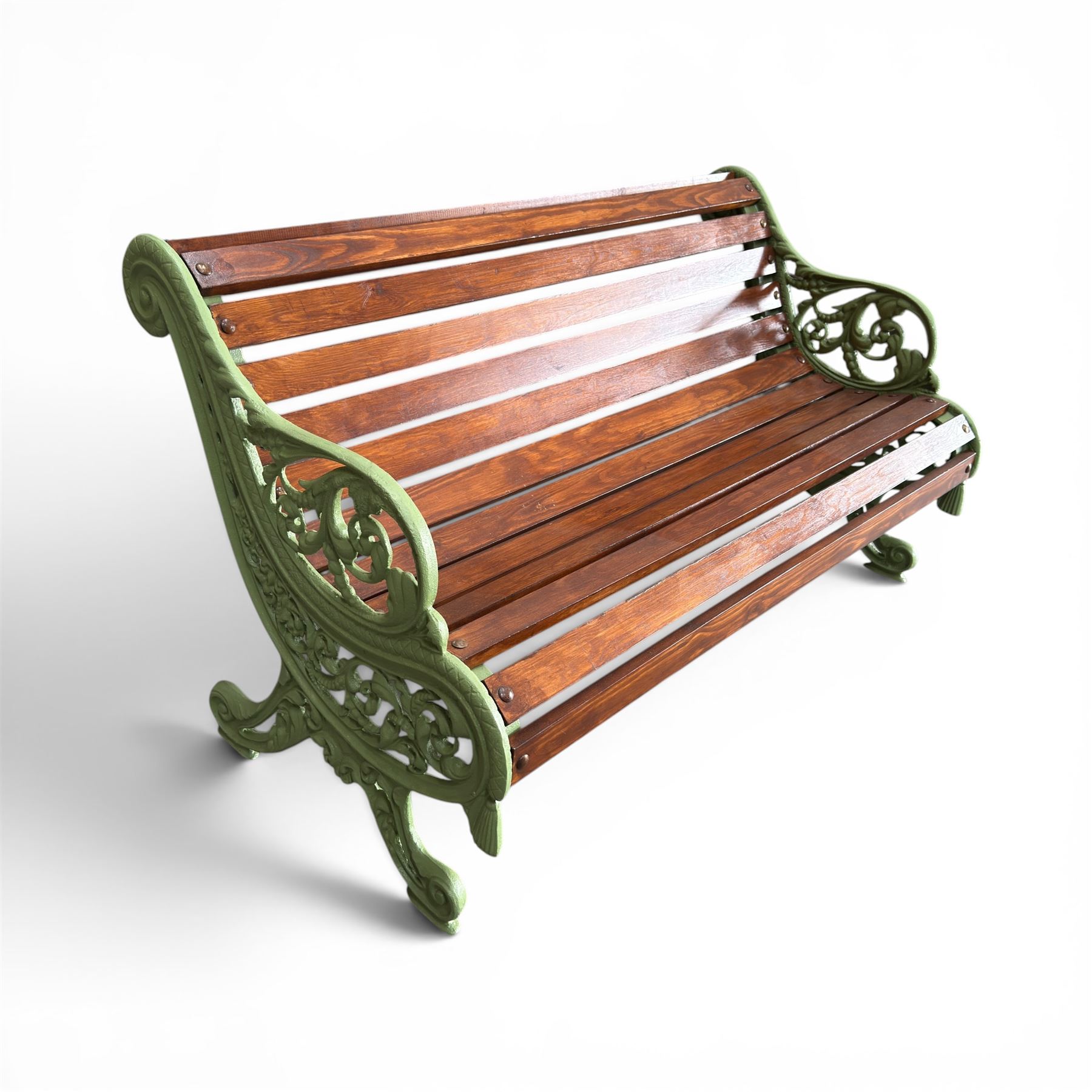 Pair of Victorian design cast iron and slatted wooden garden benches, the ornate pierced end supports of scrolled form, the pierced acanthus leaves interspersed with trailing flowerheads, with tassels to the front, raised on splayed feet, the supports in pale sage green painted finish