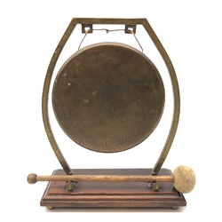  WW2 German brass gong, engraved  SS Musikschule Braunschweig, with eagle and Swastika, on curved angular supports and wooden base on four ball feet, with beater,W20cm, H26cm   
