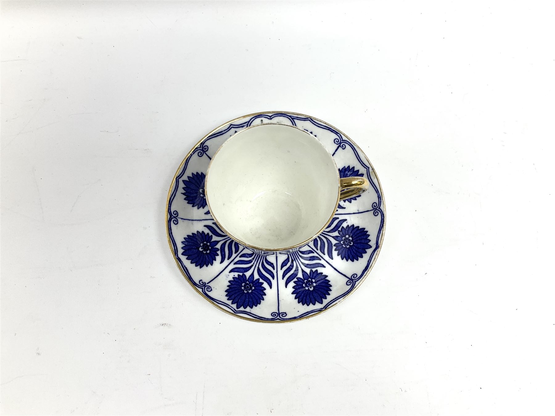 Late 19th century Coalport porcelain cup and saucer in the 'Aster' pattern bearing the crest of Express Dairy Company Limited, College Farm, Finchley and decorated with a steam locomotive