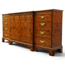 Georgian design figured and burr walnut breakfront sideboard, shaped rectangular top inlaid with crossbanding and stringing, fitted with central brushing slide over cupboard enclosing single adjustable shelf, flanked four graduating cock-beaded drawers to each side, raised on bracket feet