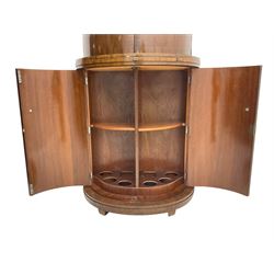 1930s Art Deco walnut demi-lune cocktail cabinet, enclosed by four curved doors, the upper section with mirrored interior, glass shelf and glass holders, the lower section fitted with shelves and bottle holders
