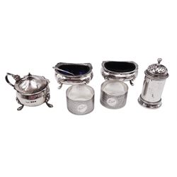 Group of silver, comprising pair of open salts, each of oval form, with shaped rim and upon four pad feet, hallmarks worn and indistinct, together with a pair of 1920s napkin rings, with engine turned decoration and personal engravings, hallmarked E J Trevitt & Sons, Chester 1923, a Victorian pepper shaker, hallmarked Barnard & Sons Ltd, London 1872,  and a mustard pot and spoon, both hallmarked