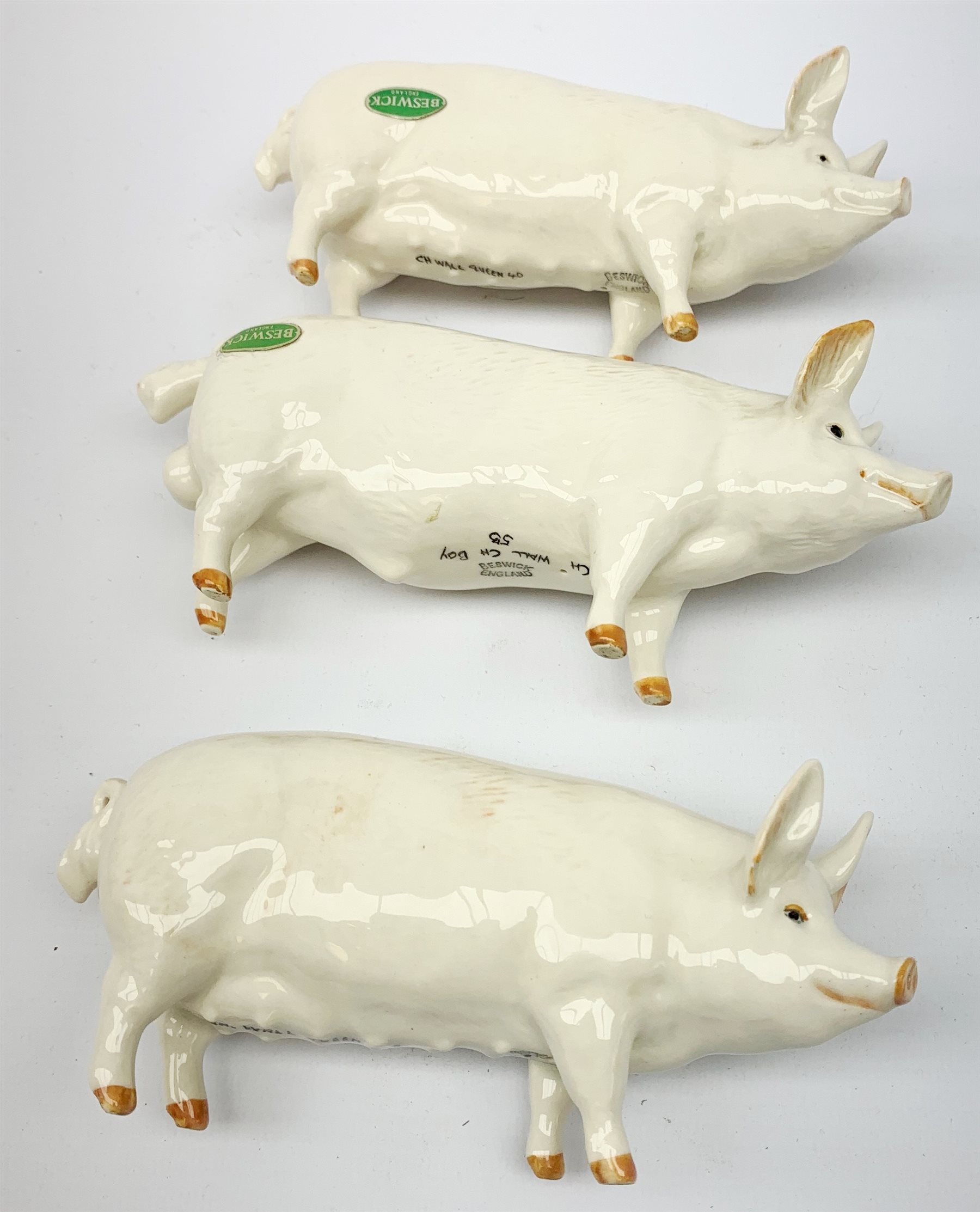 A group of Beswick figures, comprising two Charlie Wall Queen pigs, and a Charlie Wall Boy pig, two donkeys, sheep, and a lamb. 