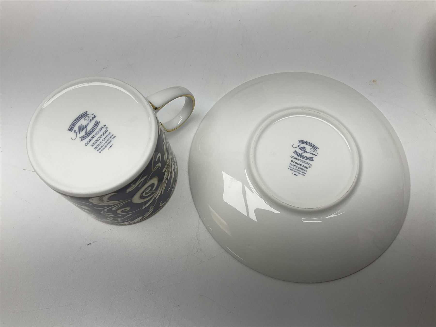 Wedgwood Cornucopia coffee service for six, comprising coffee pot, milk jug, twin handled covered sucrier, coffee cans and saucers