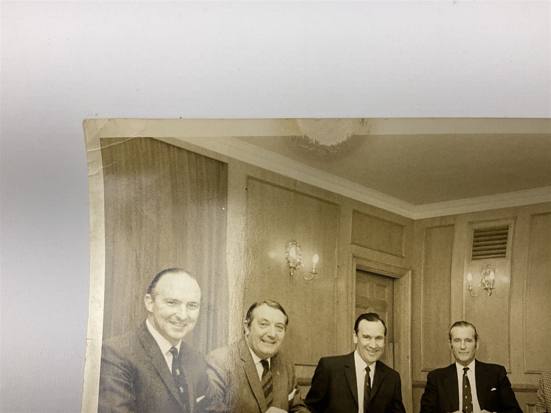 Early 1970s sepia photograph of the Pools Panel meeting at The Waldorf Hotel, London including Raich Carter, Marquis of Bath, Arthur Ellis, Neil Franklin etc 19 x 25cm; together with a beech spaghetti server with manuscript presentation inscription 'To Raich Carter from Henry 6th Marquis of Bath 1974'; Provenance: By direct descent from the family of Raich Carter having been consigned by his daughter Jane Carter (2)