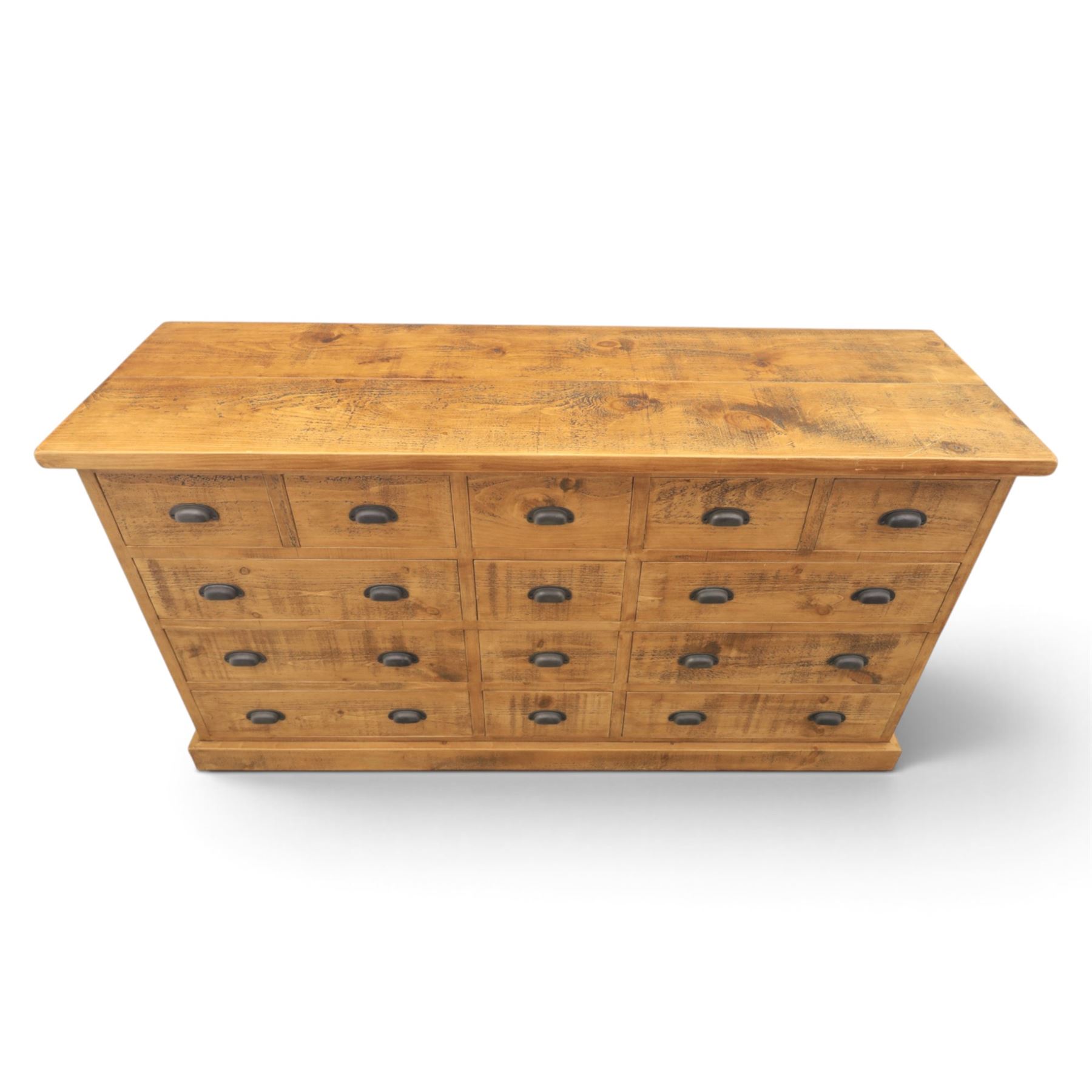 Indigo Furniture - large rustic oak combination chest sideboard, fourteen drawer with blackened metal cup handles, on a plinth base
