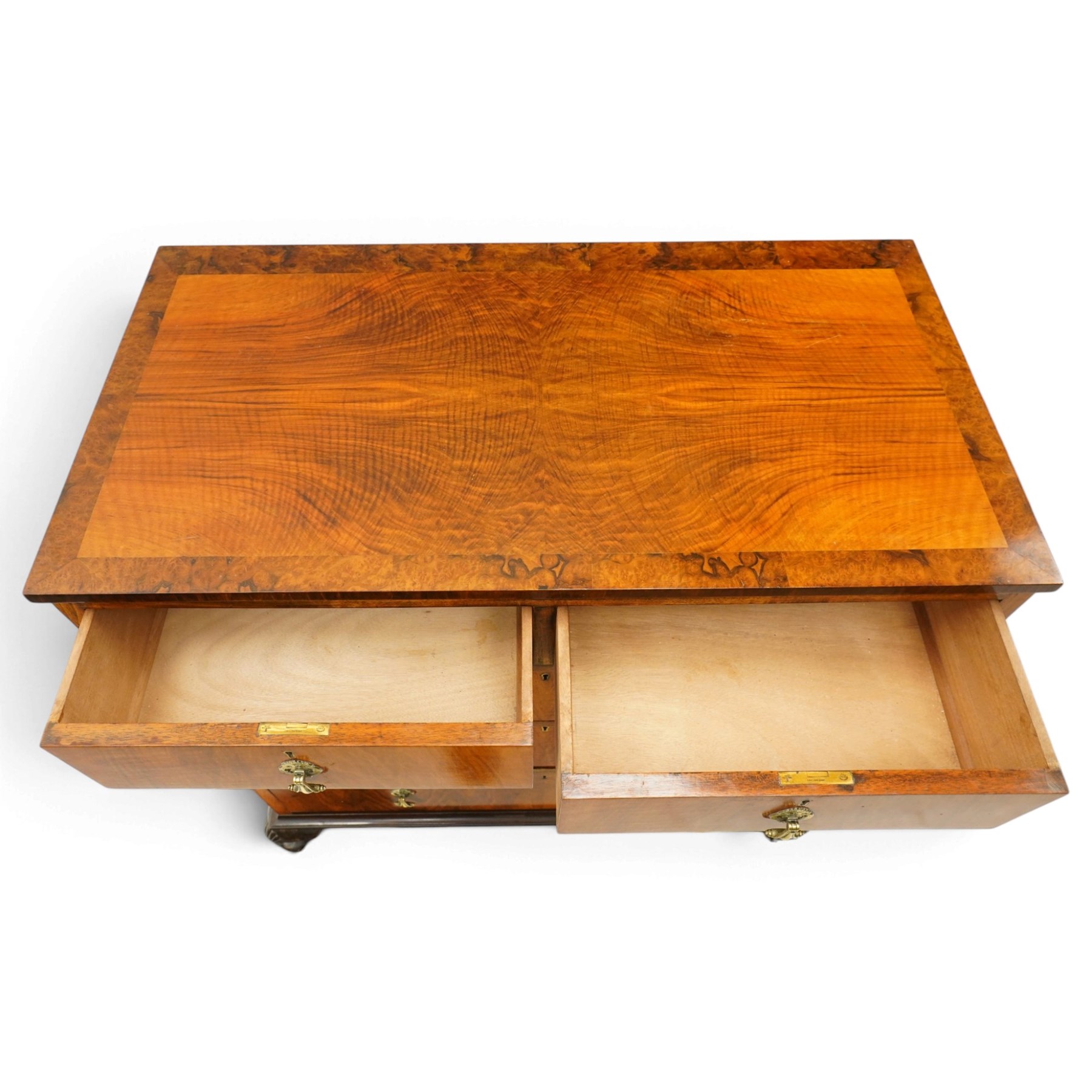 Early 20th century figured walnut chest, rectangular top with burr crossbanding, fitted with two short over three long drawers with brass drop-handles, lower moulded edge over shell-carved cabriole feet