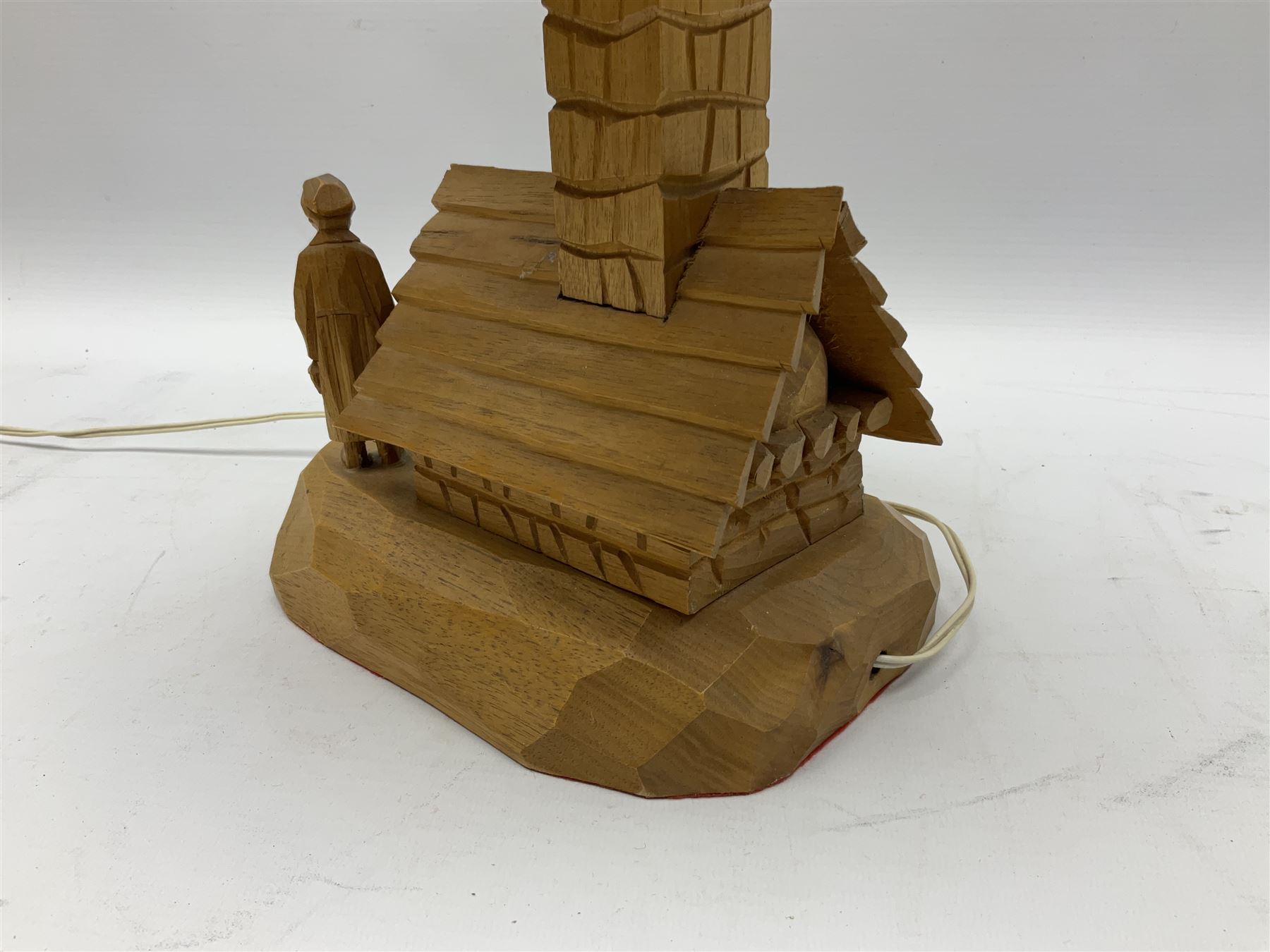 Mid 20th century Paul Caron carved table lamp, modelled as man standing before an oven, the chimney supporting the panelled shade, the base signed P.E. Caron, H42cm