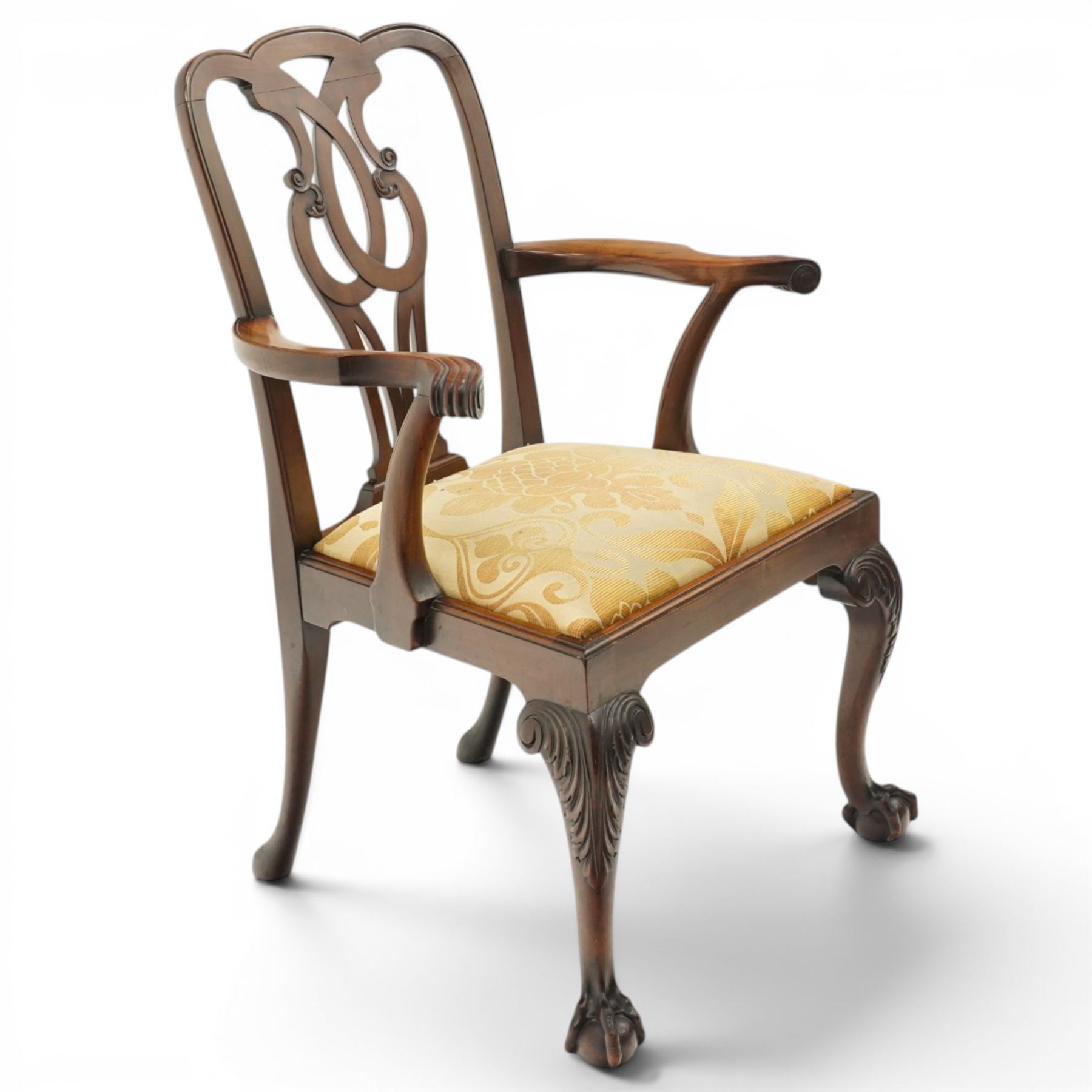 Late 19th century Chippendale style mahogany desk chair, with pierced splat and shaped and scrolled arms, raised on front claw and ball supports