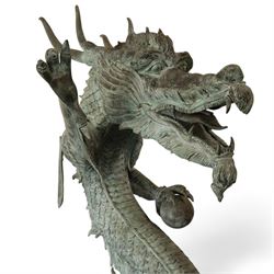 Verdigris hand finished cast brass Chinese Dragon garden centre-piece fountain, scaled dragon with gaping jaw holding an orb, curled tail on wave cast base