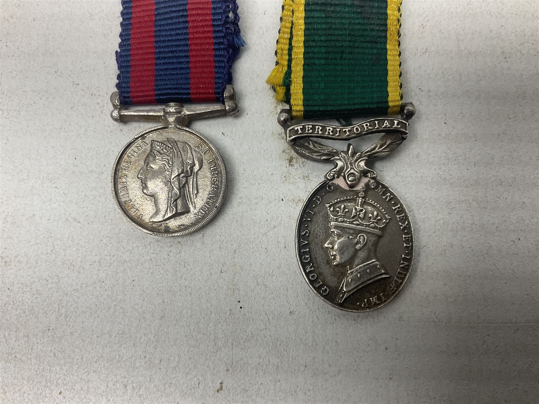 George V Military Medal and Distinguished Conduct Medal miniature group of seven medals comprising MM, DCM, WW1 trio including 1914 Star with date clasp and MID leaves, The Great Durbar Delhi 1911 Medal and LSGC; on pinned wearing bar; WW1 Military Medal miniature group of three comprising MM, BWM and Victory; Victoria North West Canada 1885 miniature; and George VI miniature Territorial Efficiency medal; all with ribbons