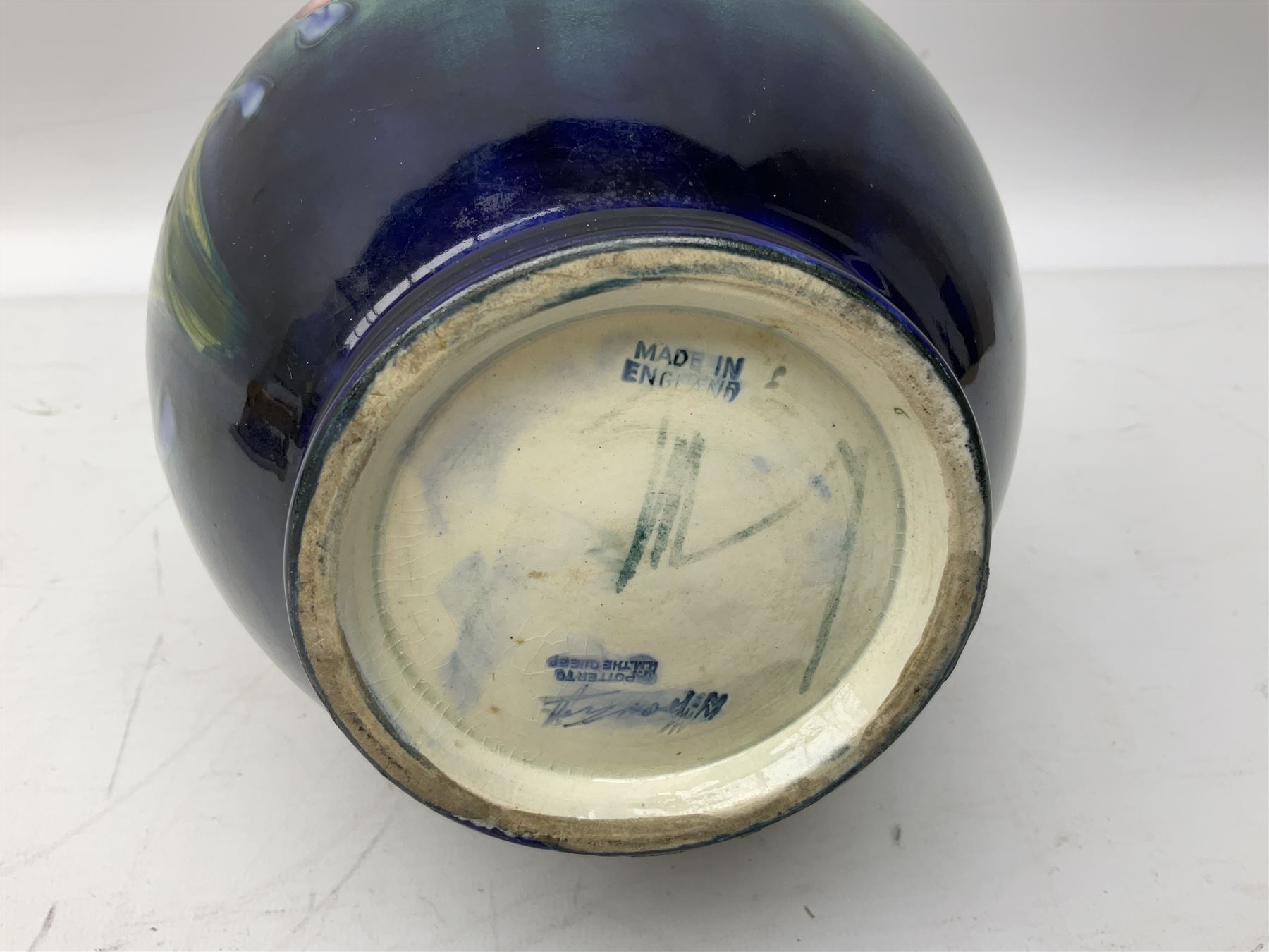 Moorcroft vase of baluster form decorated in the Spring Flowers pattern upon a merging green and blue ground, with impressed and painted marks beneath, H22.5cm