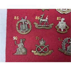 Twenty-two glengarry and cap badges including Argyll & Sutherland, Devonshire, Essex, Hampshire, Royal Berkshire, Northamptonshire, Long Range Desert Group, Royal Corps of Signals, Norfolk, Dorsetshire, East Lancashire etc; mounted on a board for display