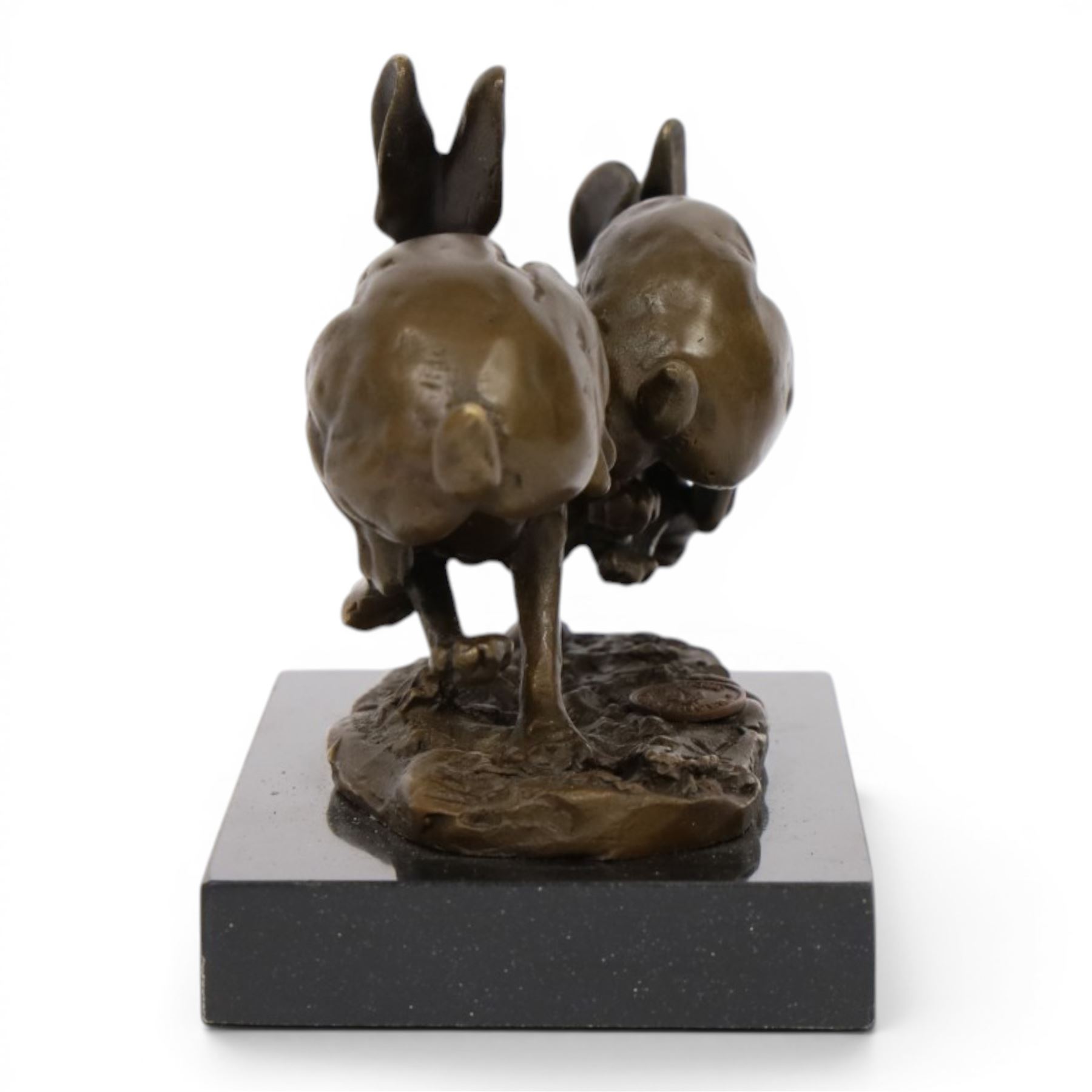Bronze figure group, modelled two hares in chase, upon naturalistically modelled oval base signed Nick and with foundry mark, raised upon black marble base, H11cm L12.5cm