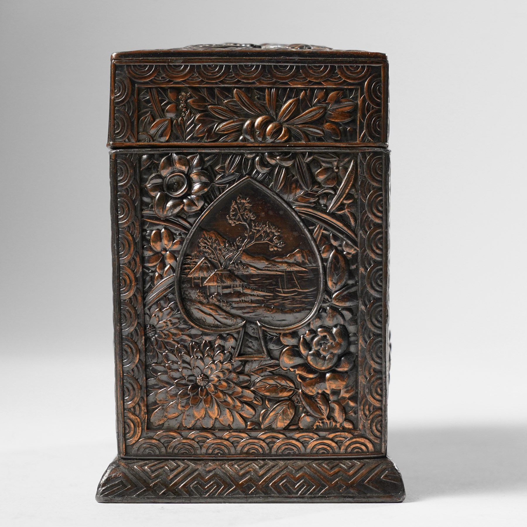 Japanese Meiji period bronze playing card box, decorated with intricate repoussé floral motifs, marked to base
