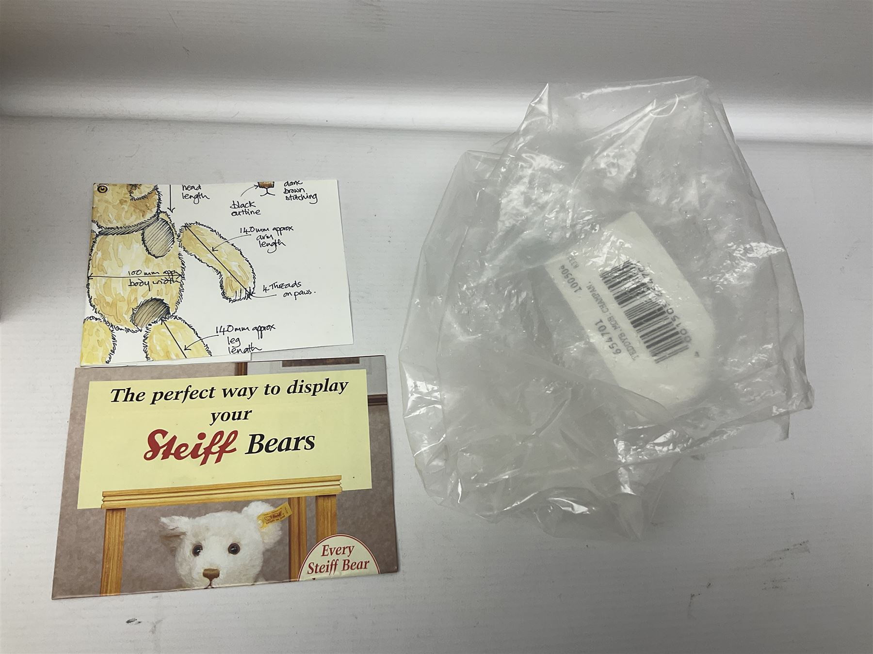 Modern Steiff teddy bear - The Millenium Bear No.34709 with golden pendant H32cm; in original box with paperwork; together with a Steiff ball-point pen in case sent to the vendor as compensation for a delay in receiving the bear.