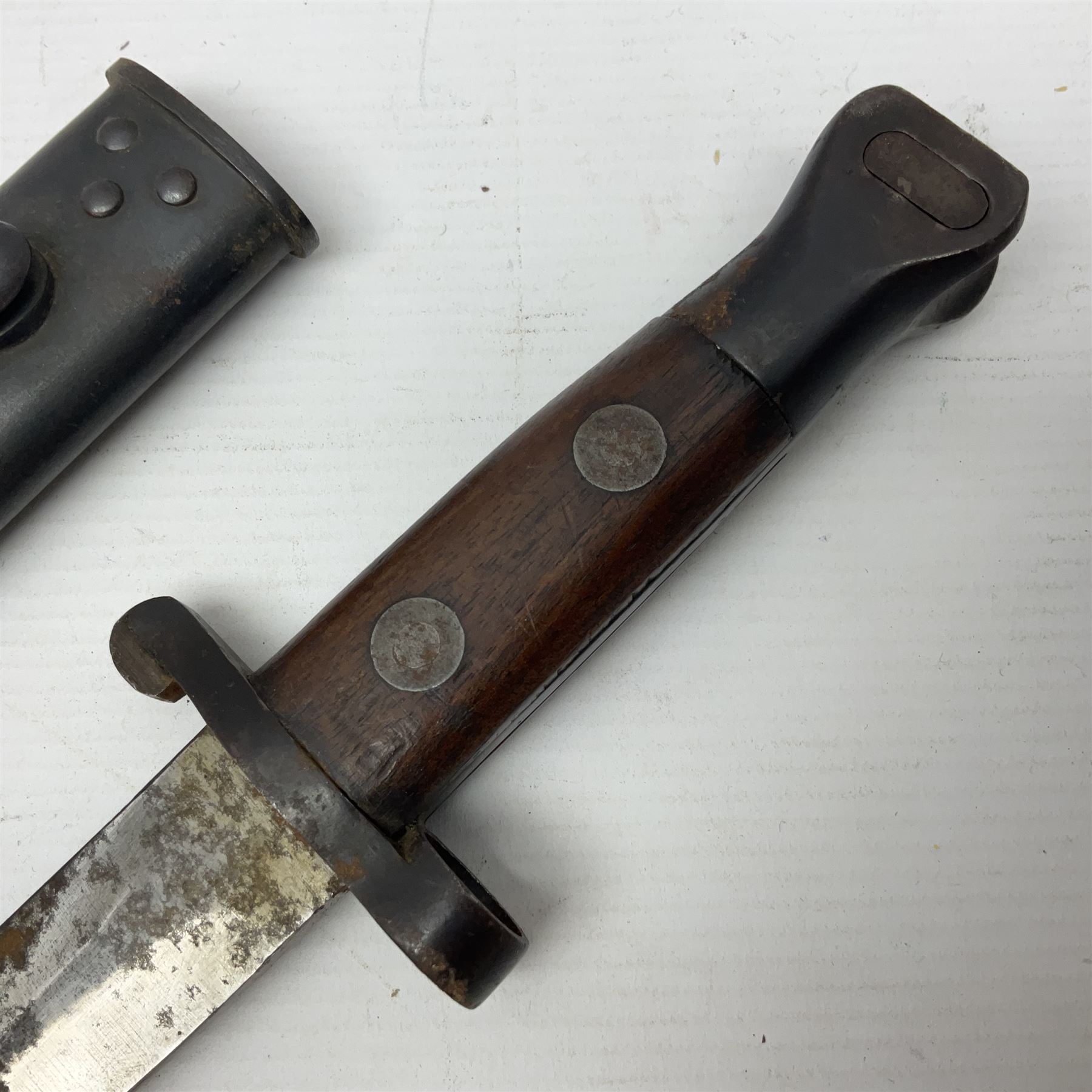 British Pattern 1888 knife bayonet, the 30.5cm double edged blade with raised central medial ridge; in leather covered scabbard L40.5cm overall