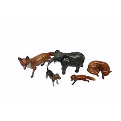 Five Beswick figures, comprising fox in recumbent pose, impressed 1017 beneath, two further foxes, a hound, and an elephant. 